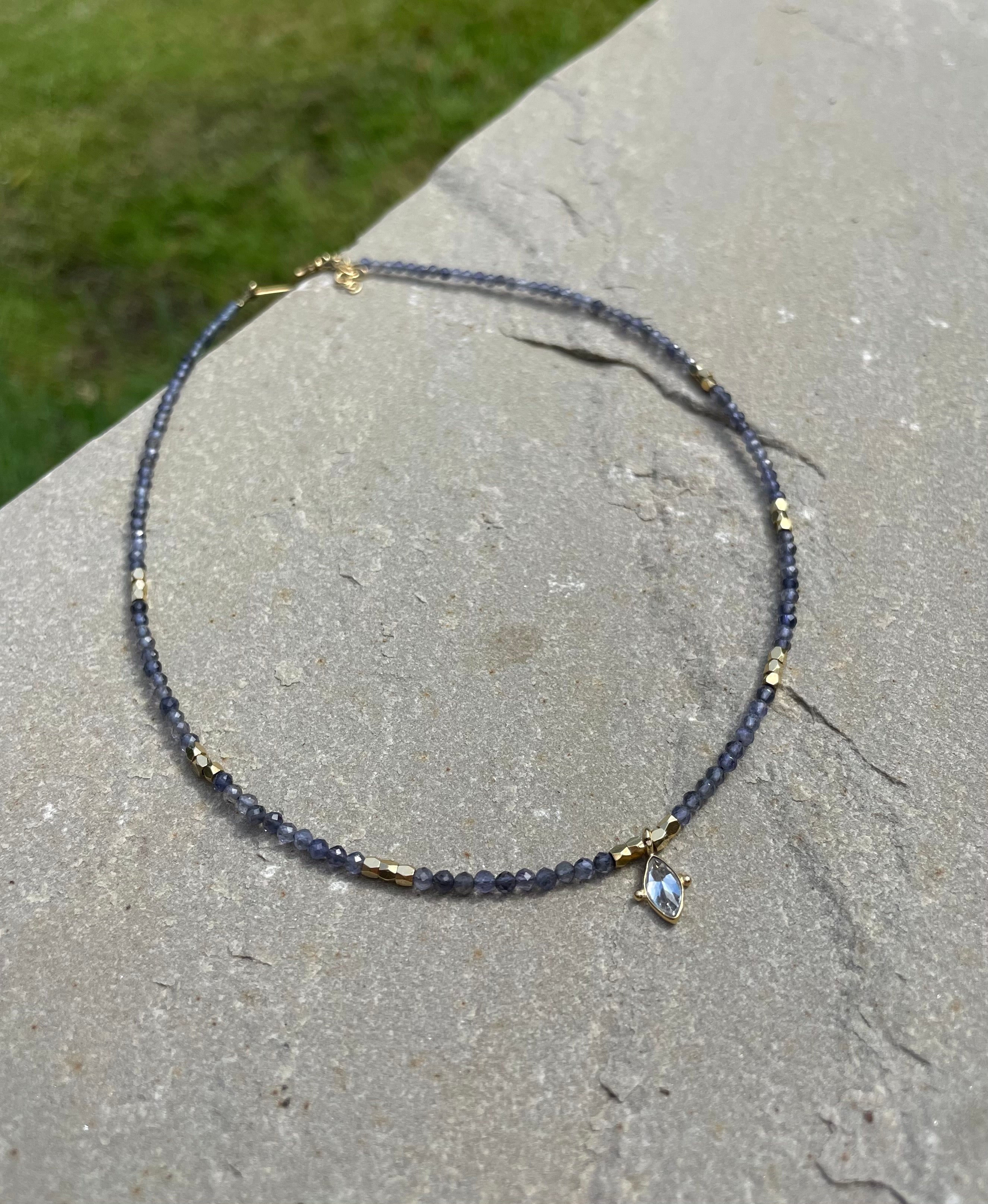 iolite choker necklace with short gold palted necklace shaped as an arrow with white embedded cubic zirconias