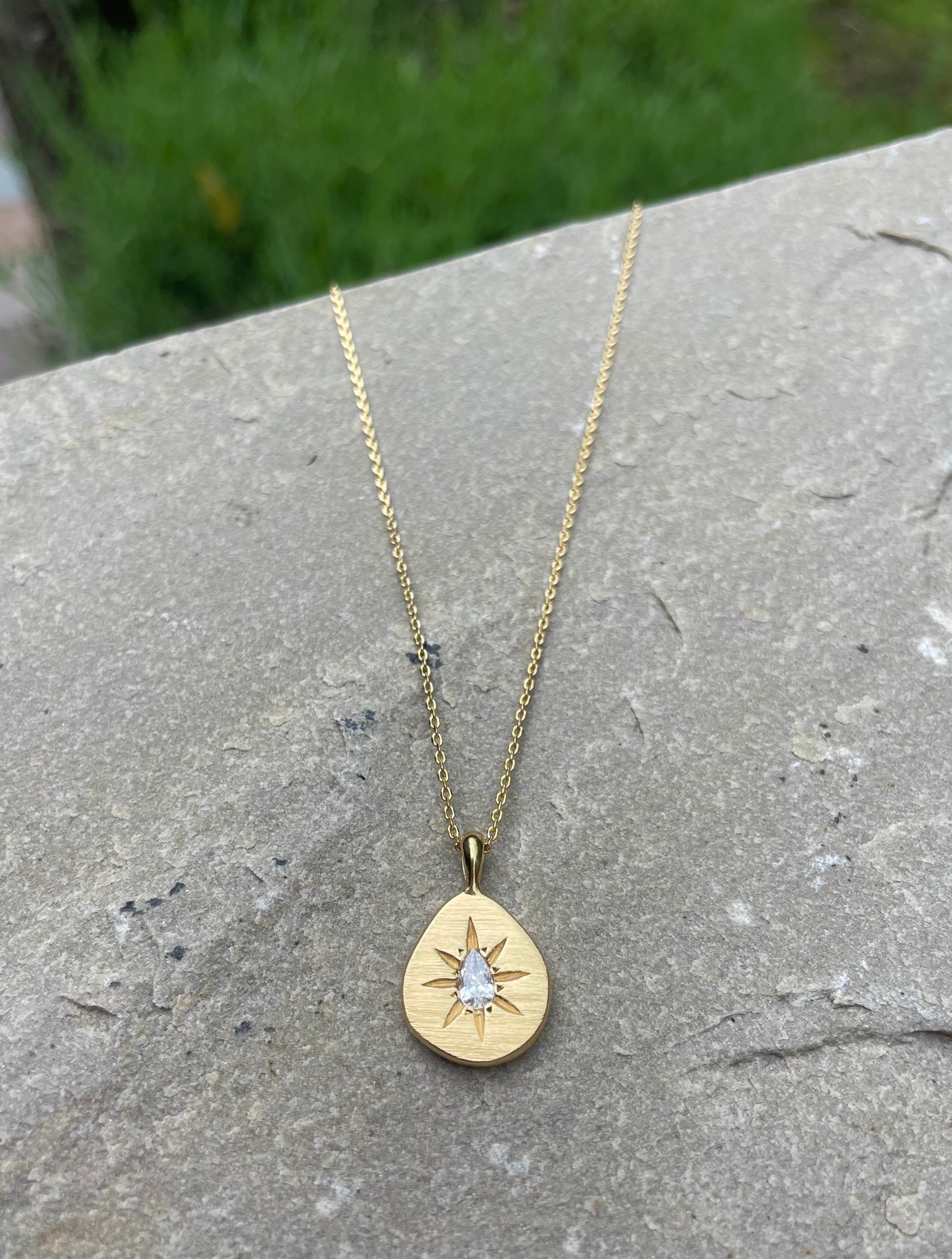 short gold plated necklace with sun medallion